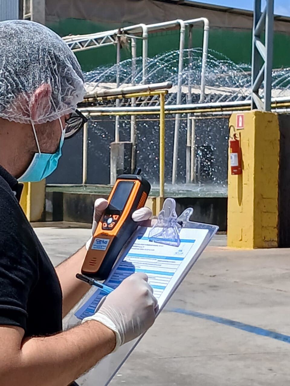 Técnico medindo material particulado no ar com medidor portátil